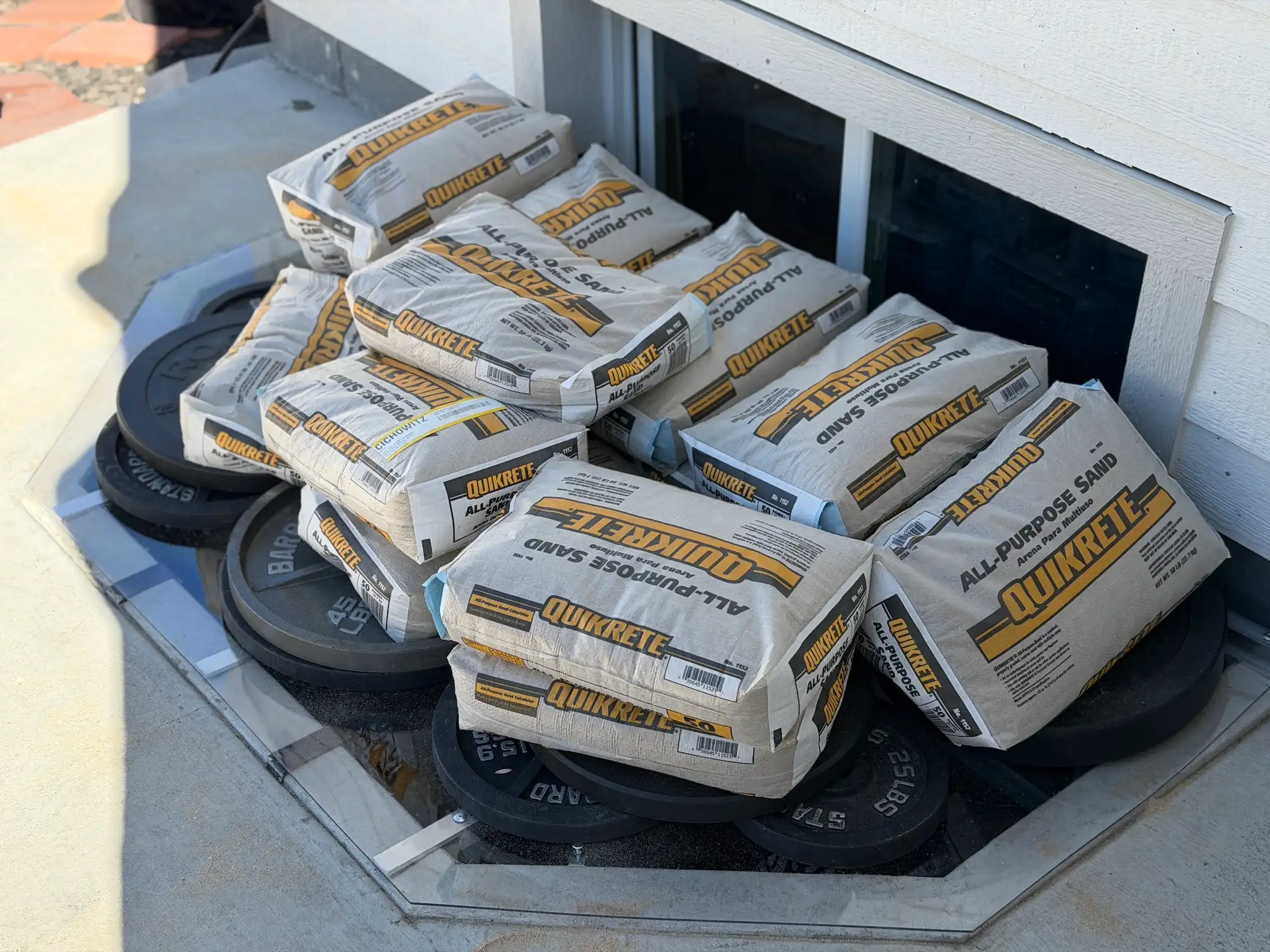 Custom window well cover supporting heavy weight load demonstrating strength and durability in Colorado conditions